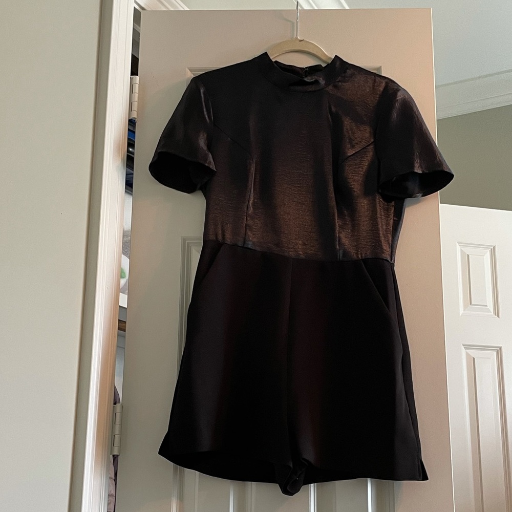 BCBG mock-neck black romper with pockets. NWT